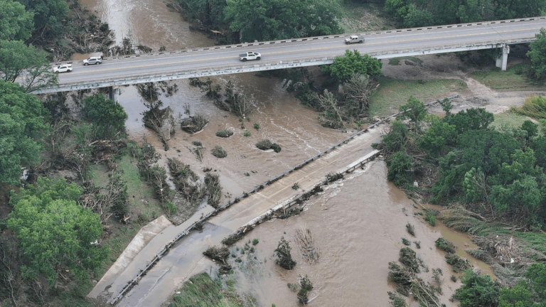 Drone view of flood-damaged roadways and bridges along the Guadalupe River near Comfort, Texas, after flash flooding.