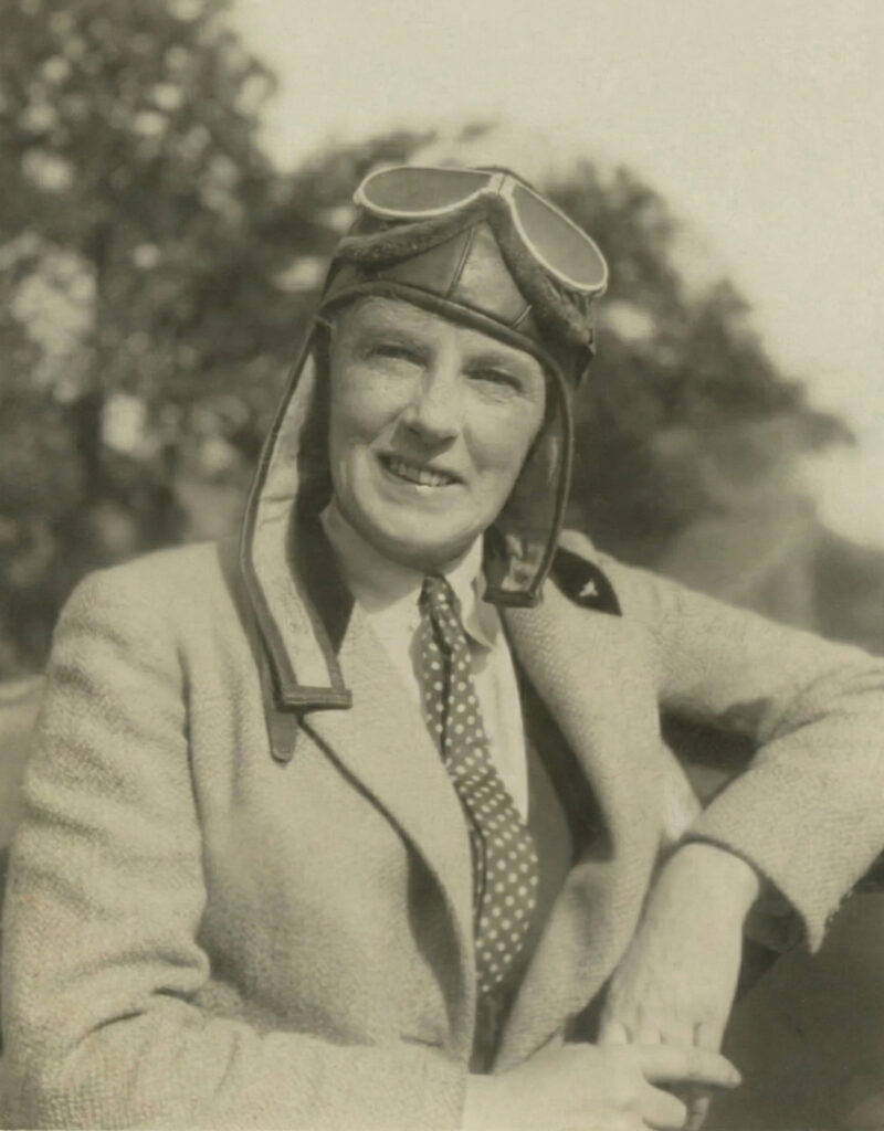 Portrait of Edith Keating, Aerial Photography's First Woman Pioneer, wearing early aviation goggles and a flight cap, based on a historical photograph.