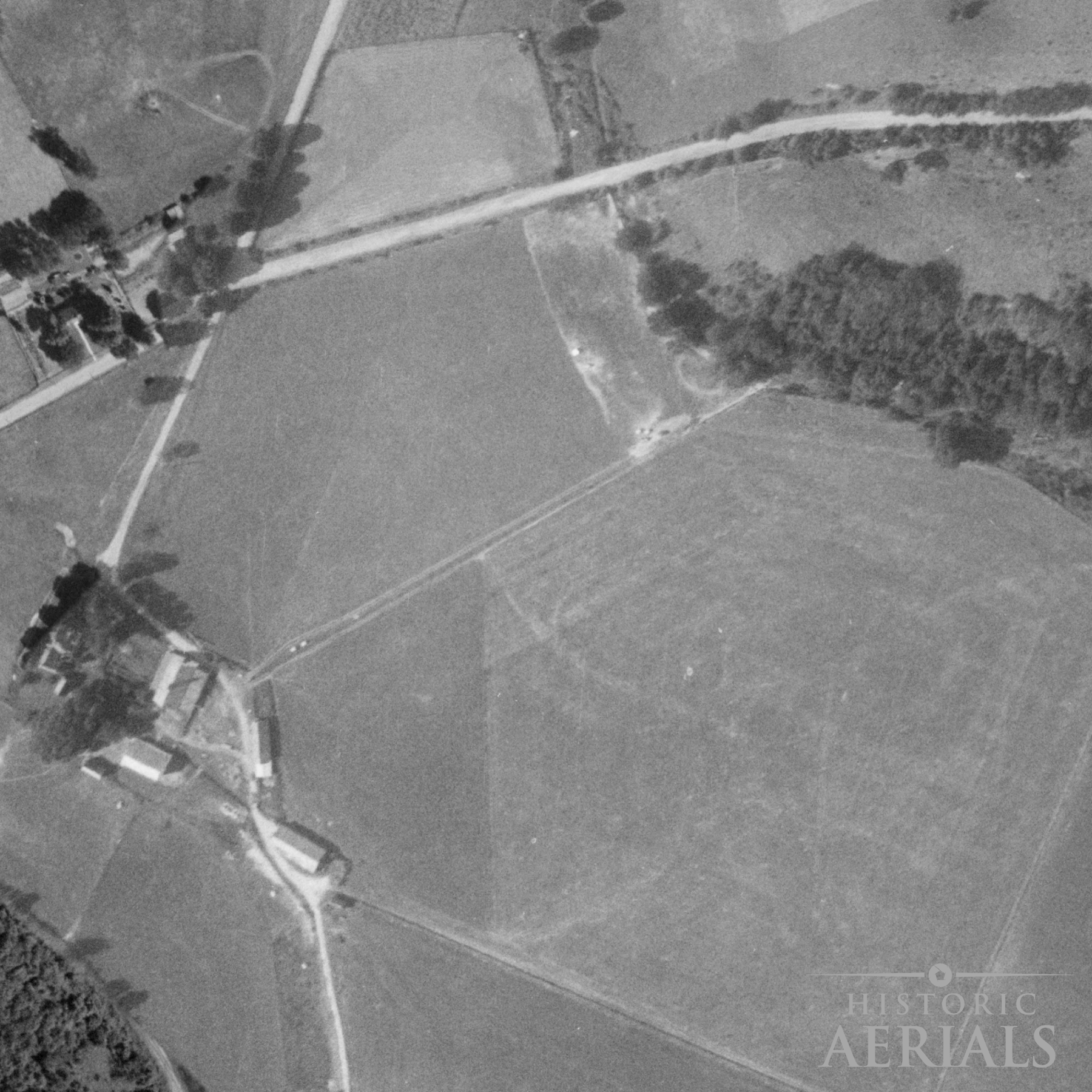 Historic aerial image of farmland and road alignments near the Junction Earthworks site in Ross County, Ohio, showing landscape conditions in 1957.