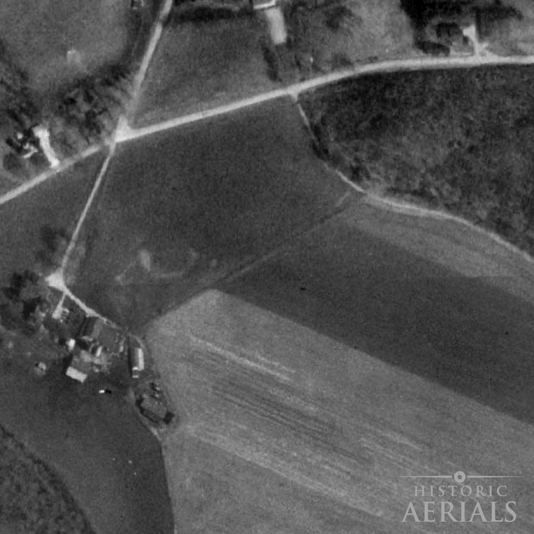 Historic aerial image of farmland and road alignments near the Junction Earthworks site in Ross County, Ohio, showing landscape conditions in 1994.