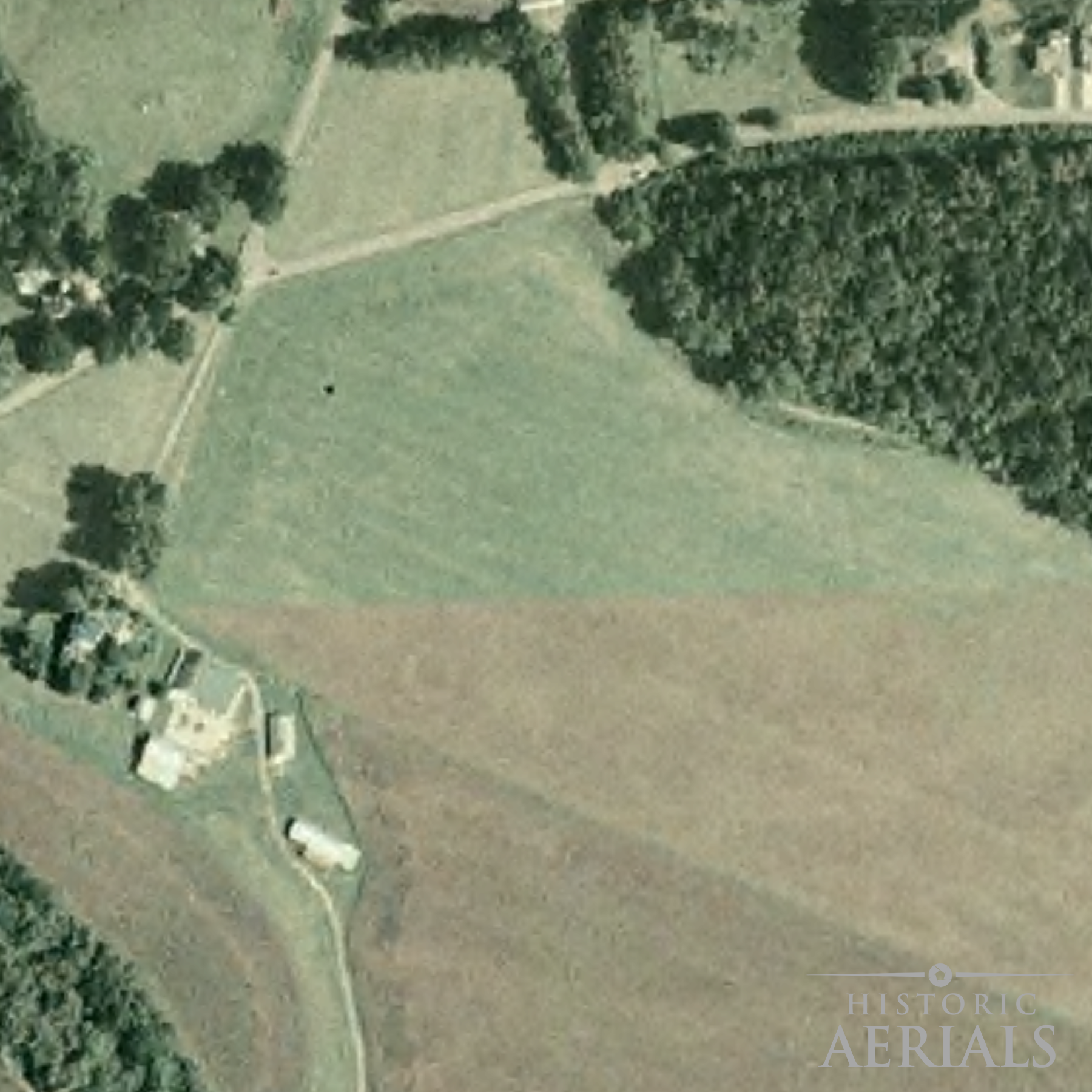 Historic aerial image of farmland and road alignments near the Junction Earthworks site in Ross County, Ohio, showing landscape conditions in 2004.