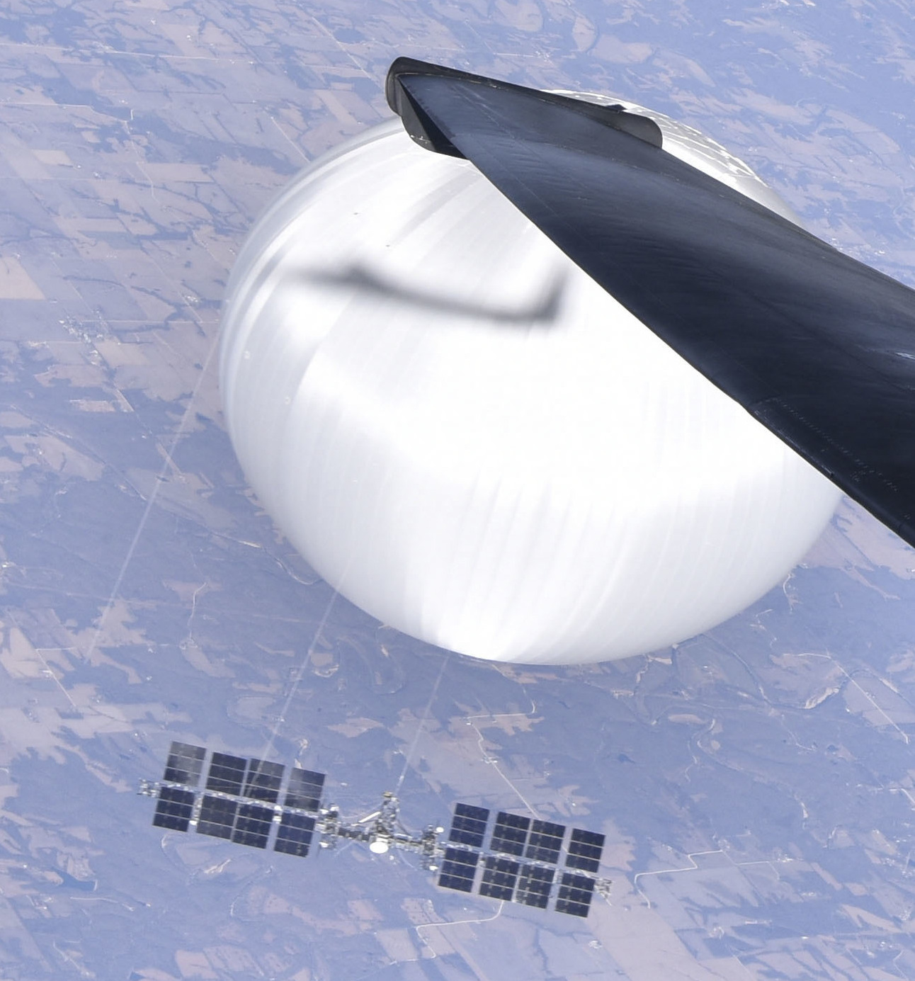 View from a U.S. Air Force aircraft showing a high-altitude balloon and payload over the continental United States in February 2023.