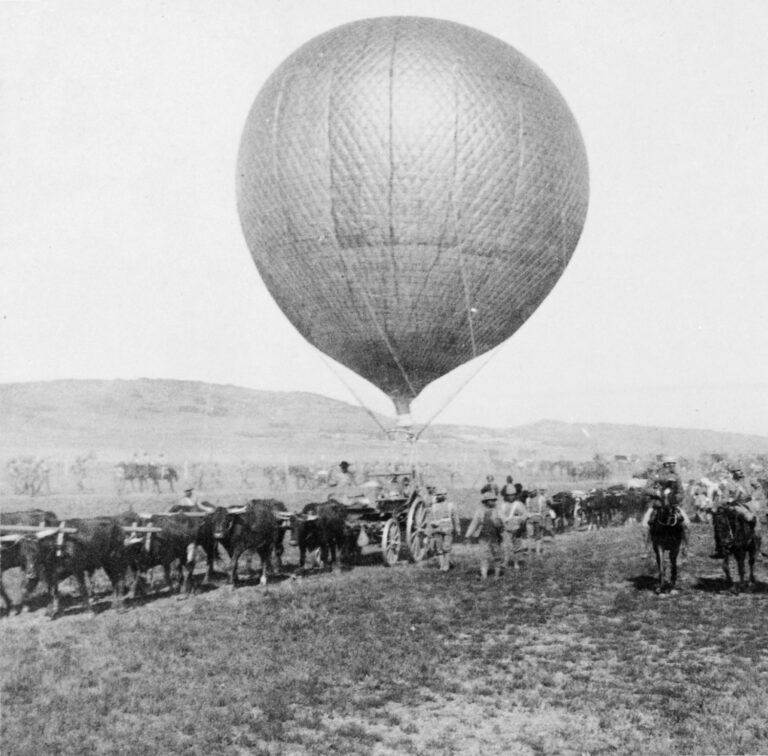 Tethered British military observation balloon supported by a wagon team during the Second Boer War.