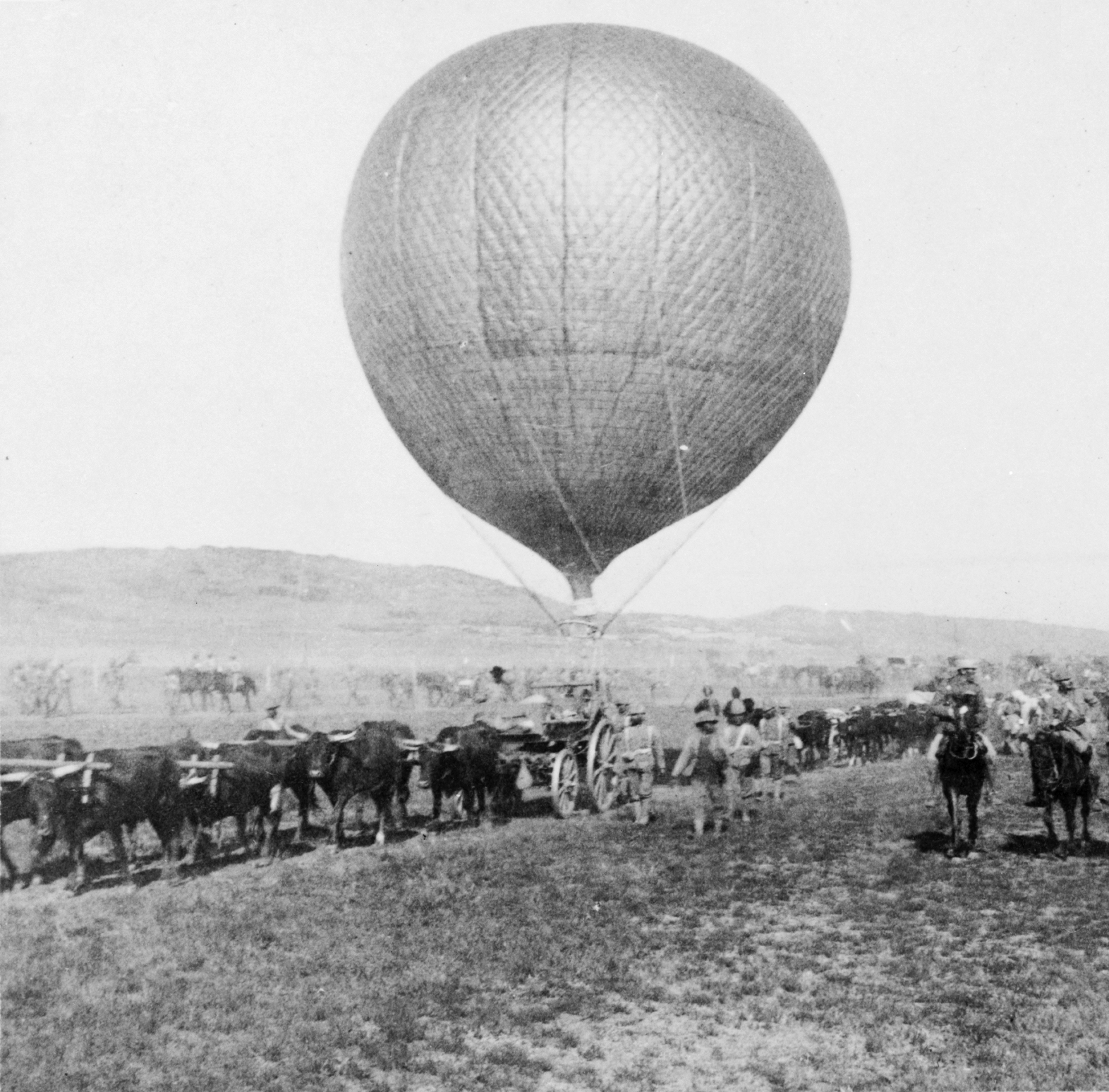 Tethered British military observation balloon supported by a wagon team during the Second Boer War.