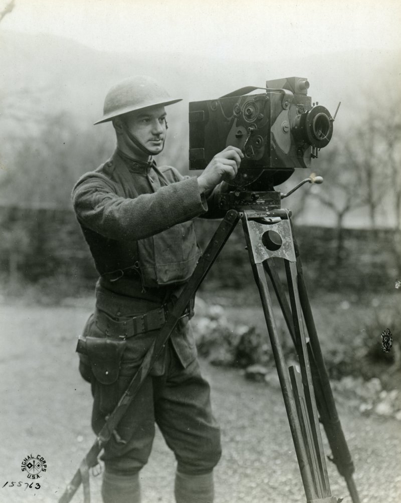 U.S. Army cameraman Sgt. Charles Ritchie operating a motion picture camera on a tripod in Germany, 1919.