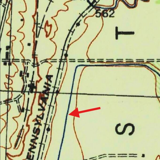 Detail of a 1944 topographic map of Cuylerville, New York, with a red arrow pointing to a straight blue watercourse beside a railroad line.